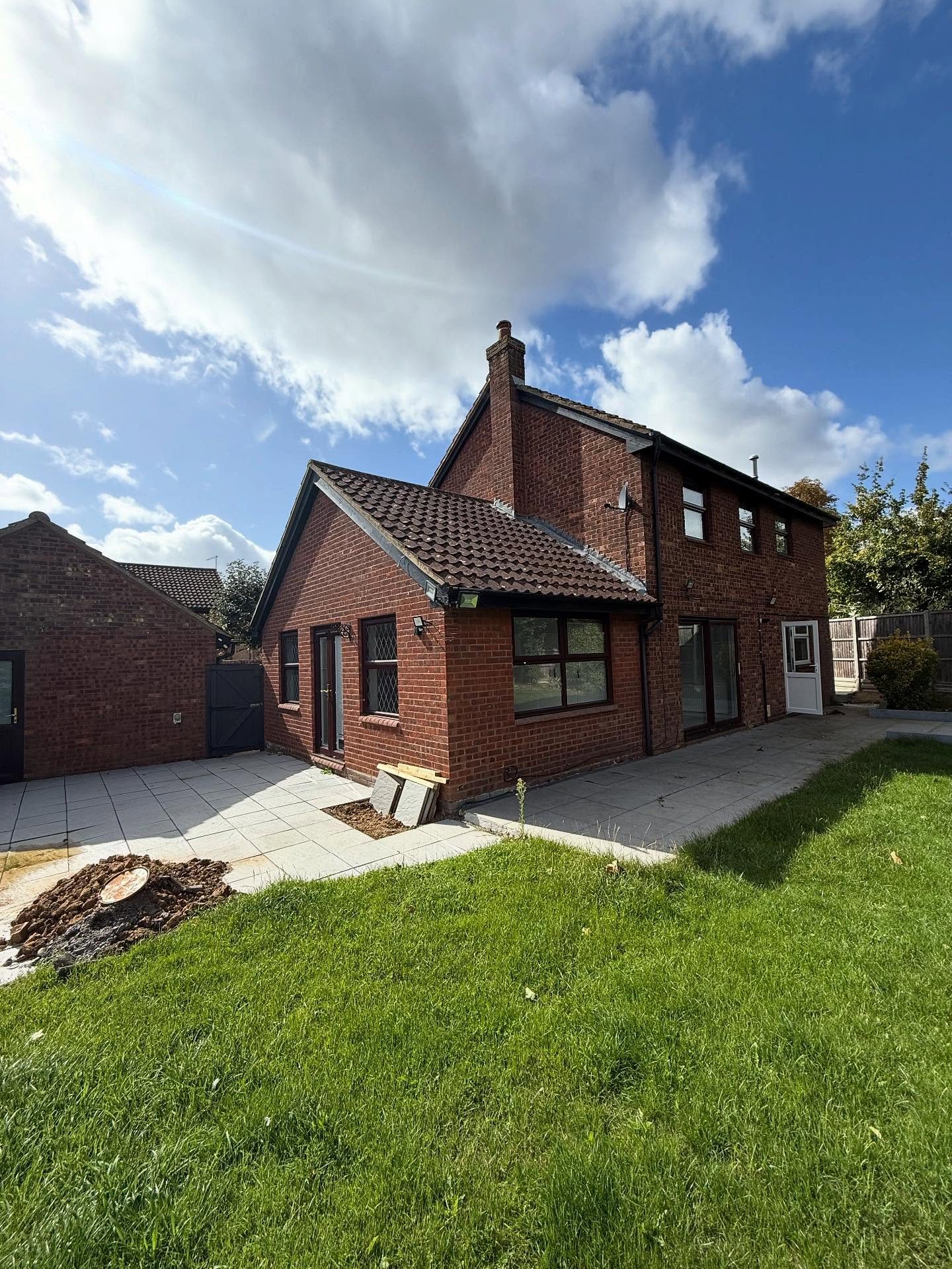 Brick rear extension with patio being laid