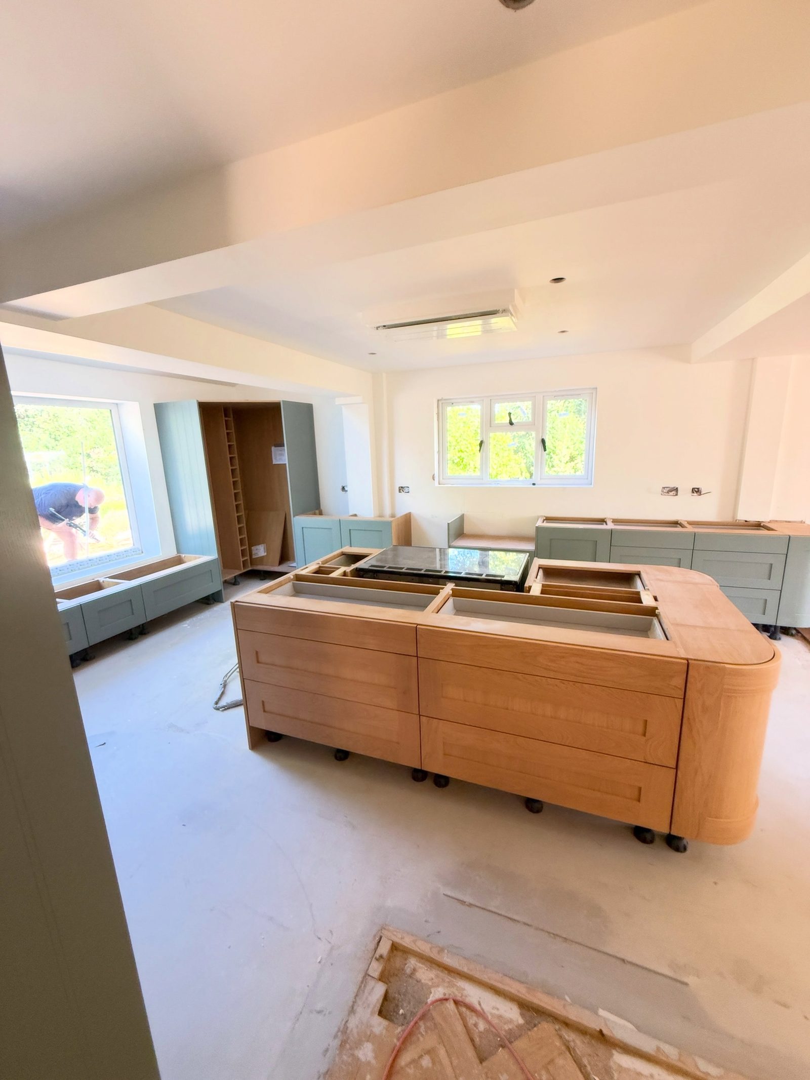 Bespoke oak and sage kitchen with window seats